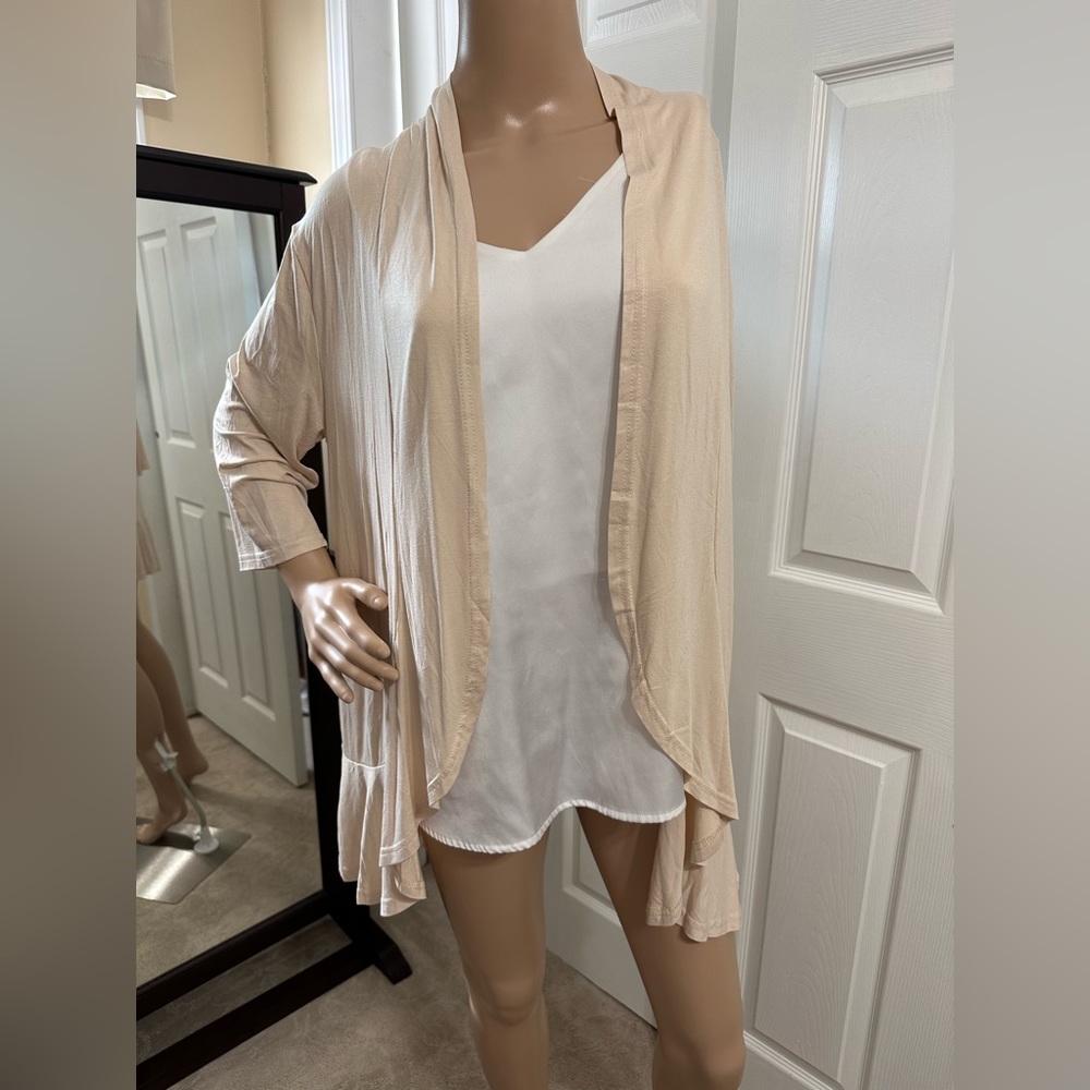 Light, beige wrap around jacket with a bottom pattern that I hope you can see.